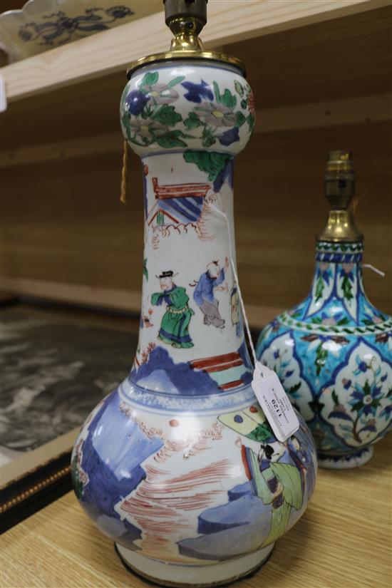 A Chinese wucai garlic-mouthed vase, late 17th century, restored, hole to base and an Isnik style baluster vase, possibly Kutahya (both